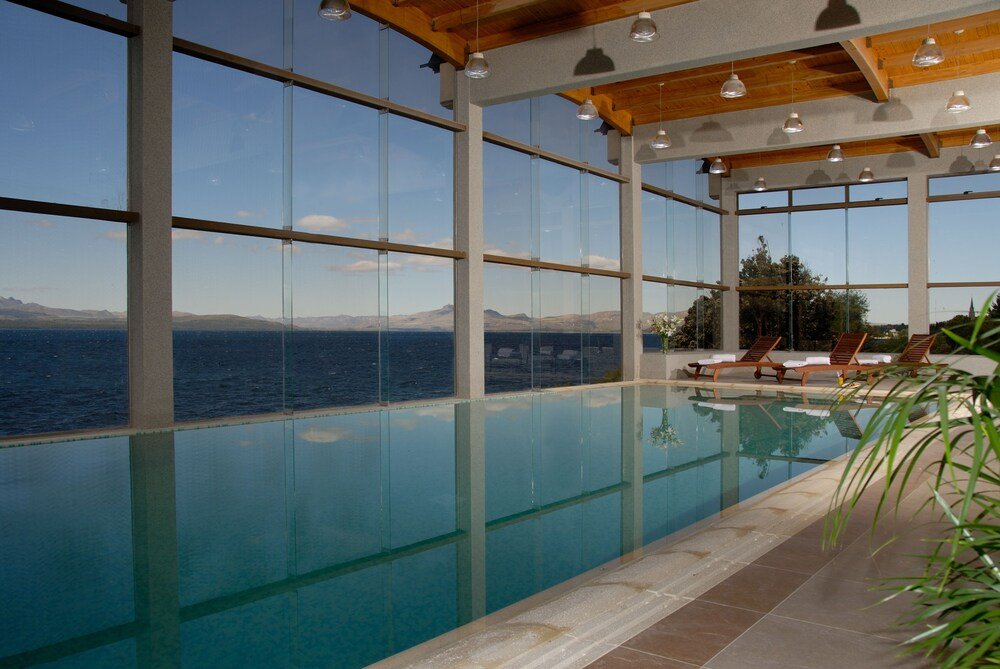 Indoor swimming pool with large windows at Alma del Lago Suites