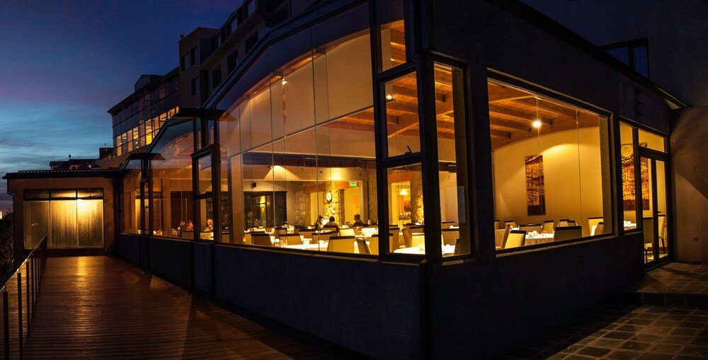 Modern building with large glass windows at Alma del Lago Suites