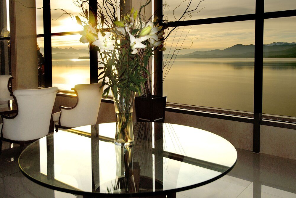 Round glass table with a vase of flowers