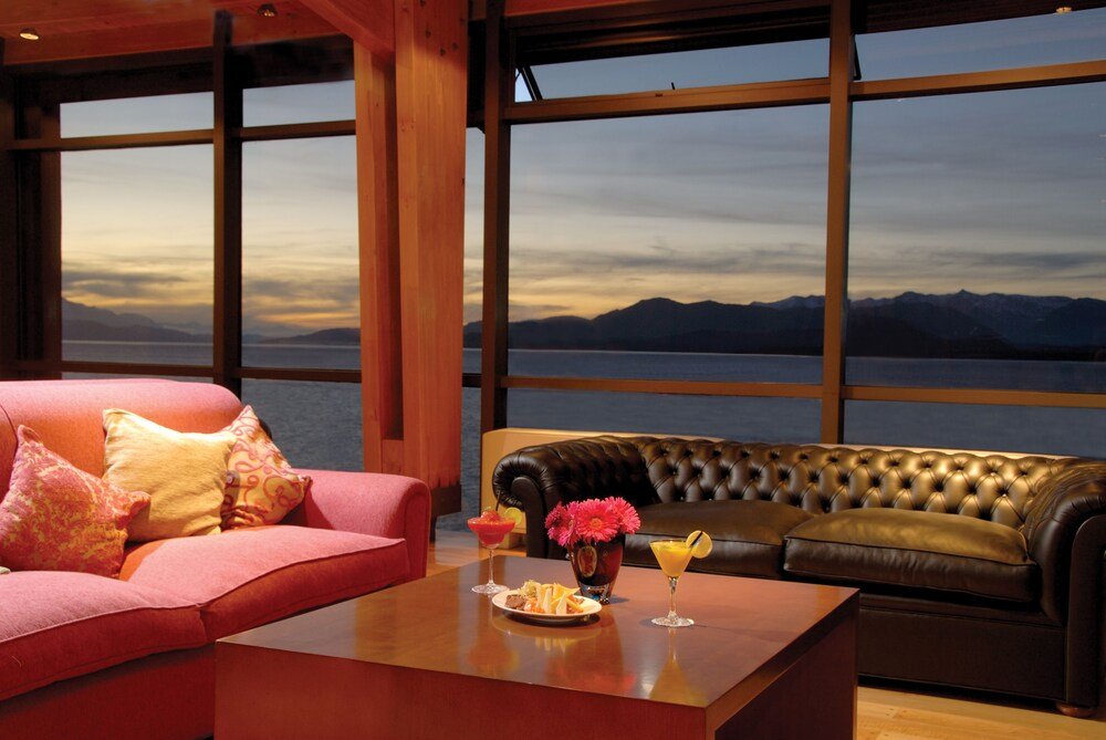 Room with a red sofa and a brown leather chair
