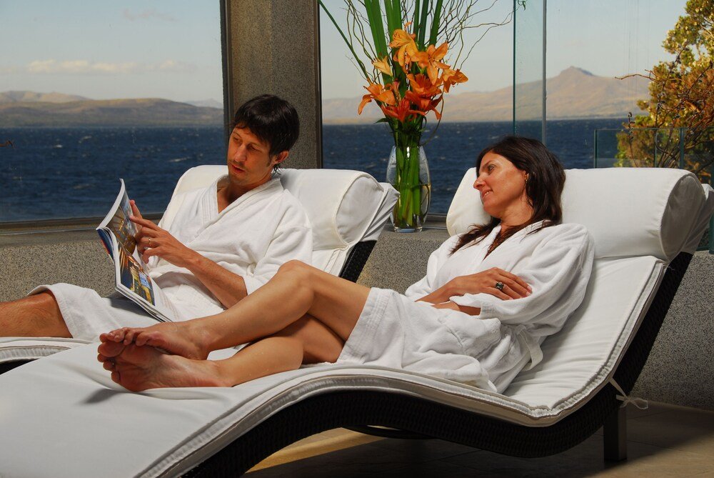 Two people in white robes relaxing at the spa