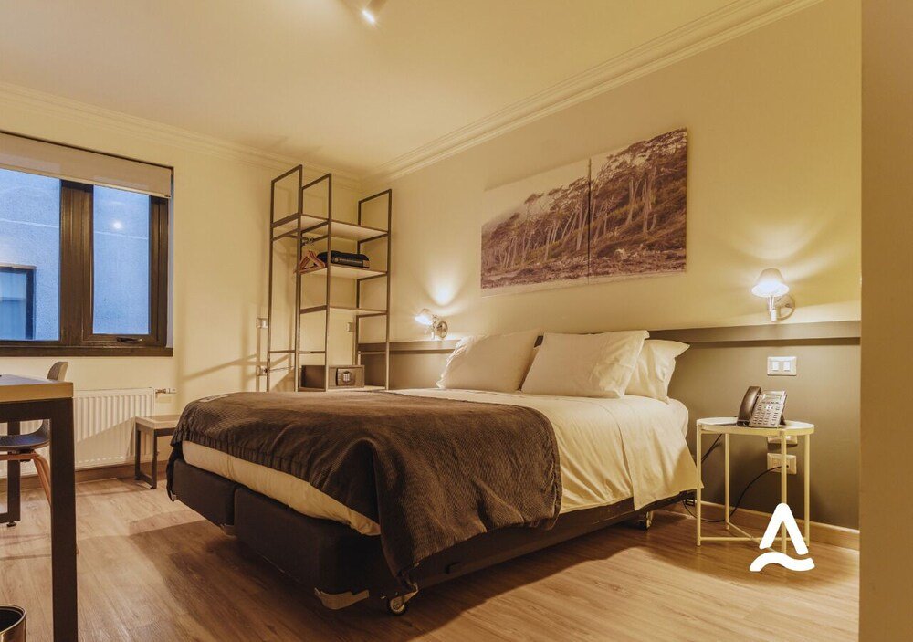 Bedroom with a bed and bedside tables at Almasur Express