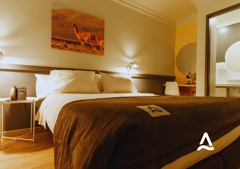 Hotel room with a bed and bedside tables at Almasur Express