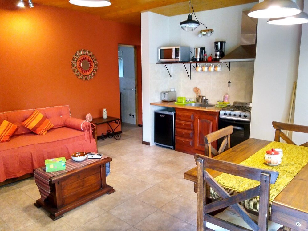Compact living space with a sofa, a dining table and a kitchenette