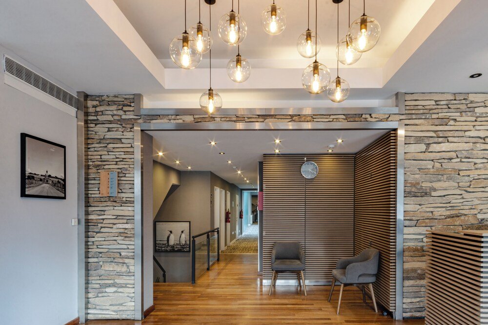Modern interior with a stone wall and wooden flooring