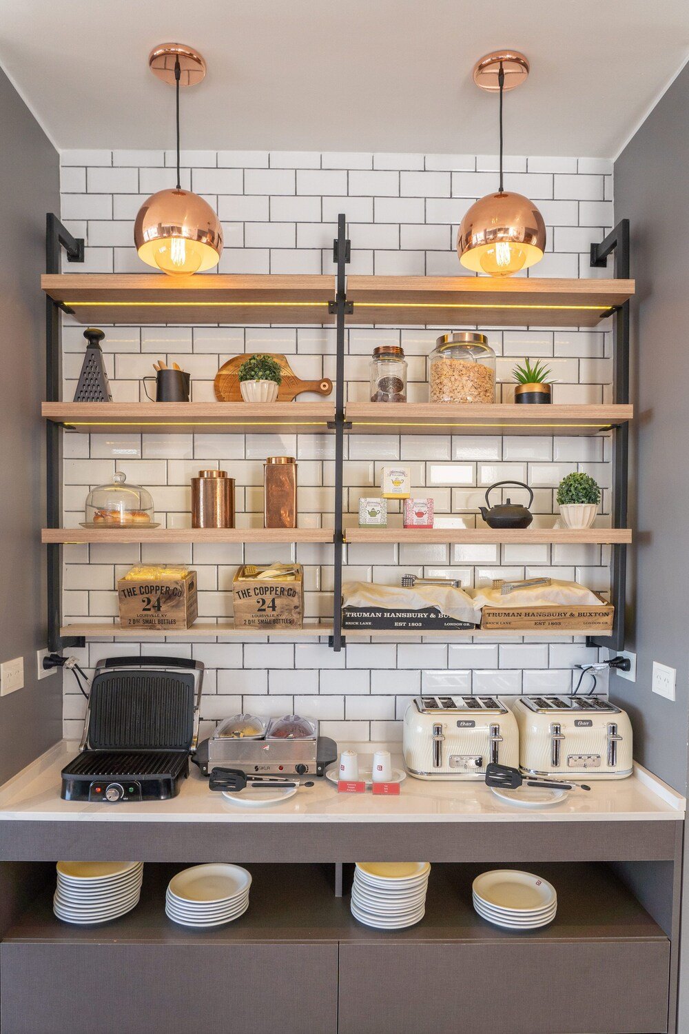 Kitchen with copper pendant lights and white brick backsplash