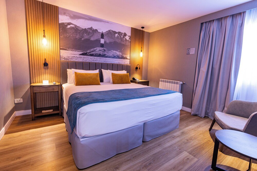 Modern hotel room with a large bed and a chair