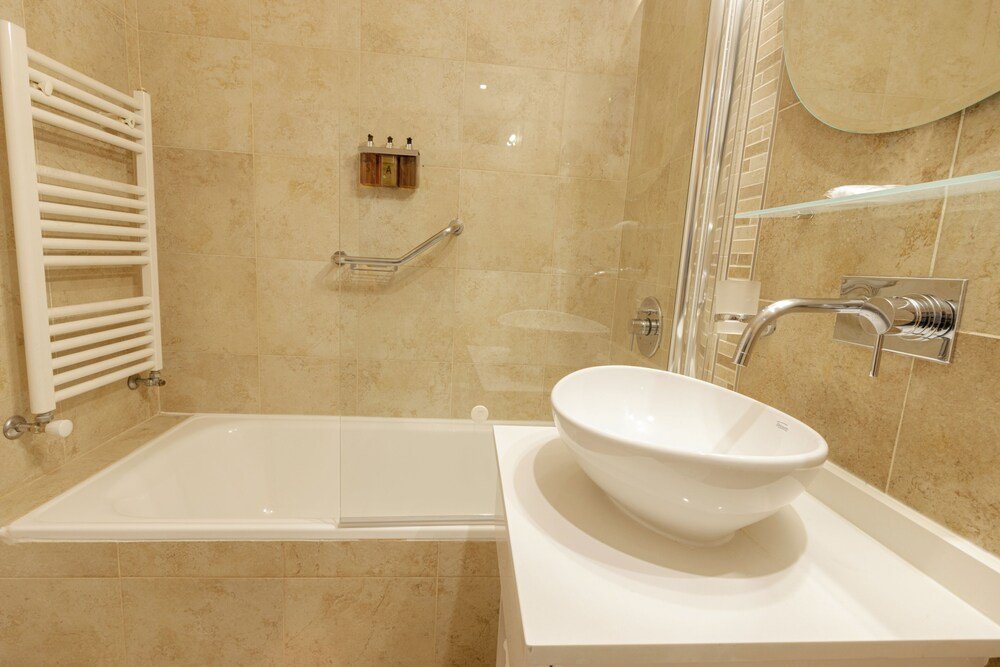 Modern bathroom with a bathtub and a glass shower