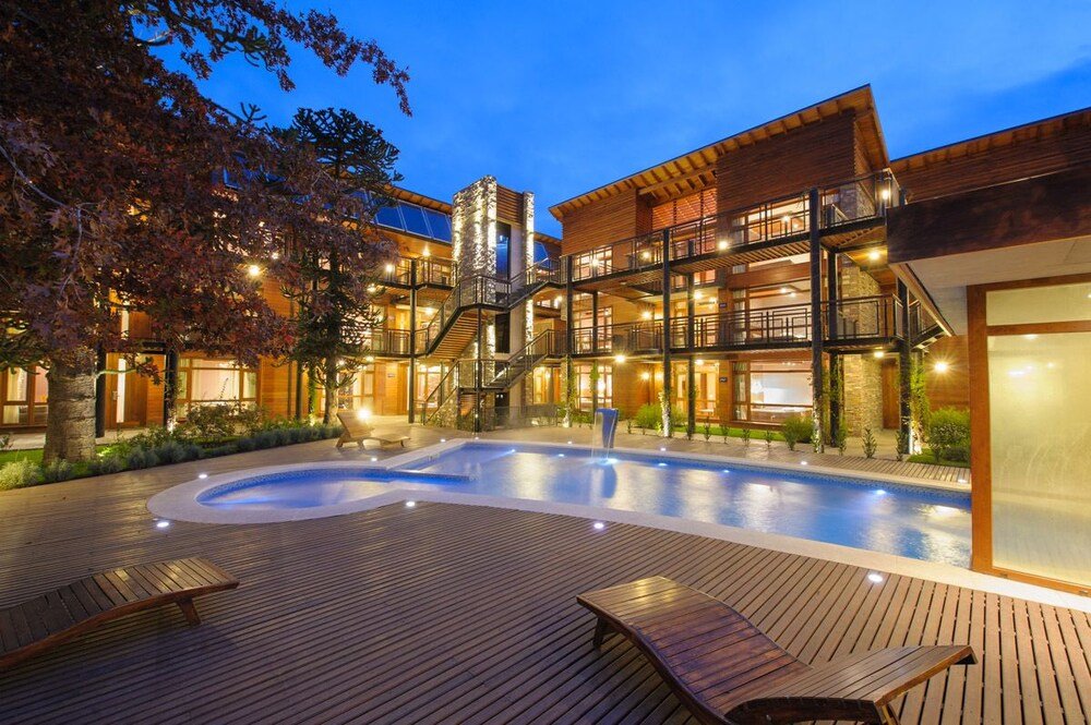 Modern aparthotel with a pool and wooden decks in the garden