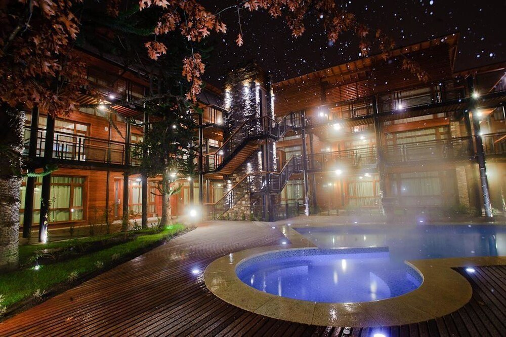Wooden decks and a hot tub in the aparthotel garden