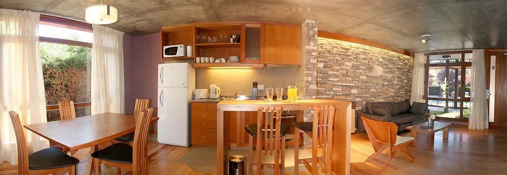 Compact kitchen with wooden cabinets in a guest apartment