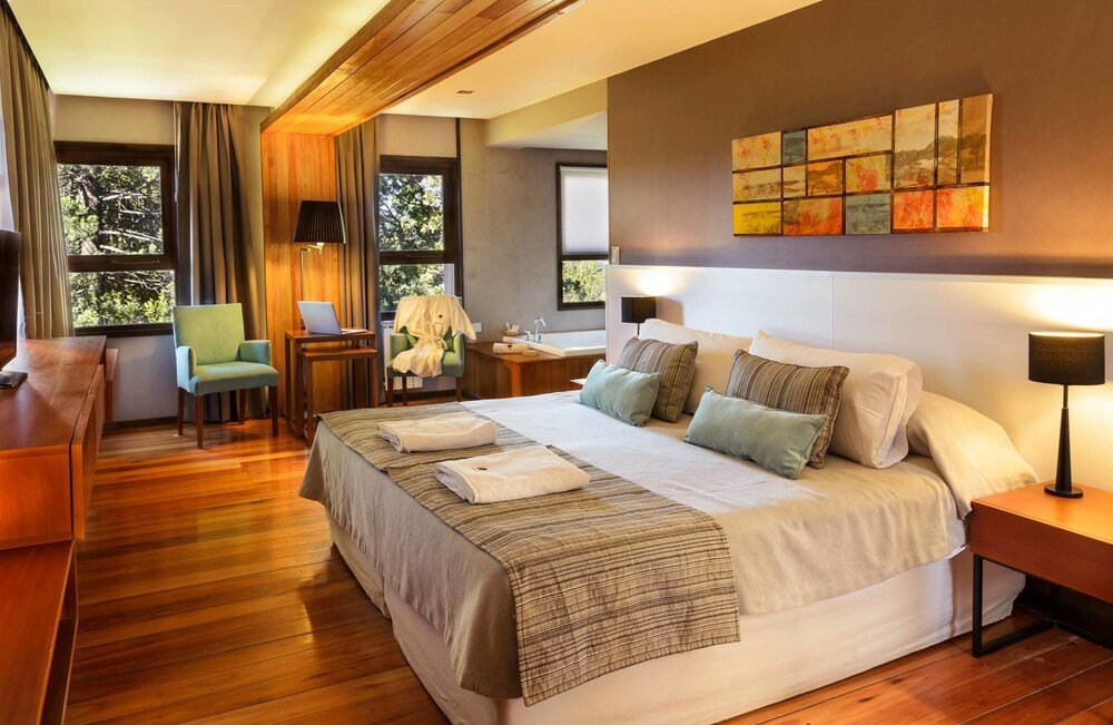 Modern hotel room with a large bed at Bosque del Nahuel