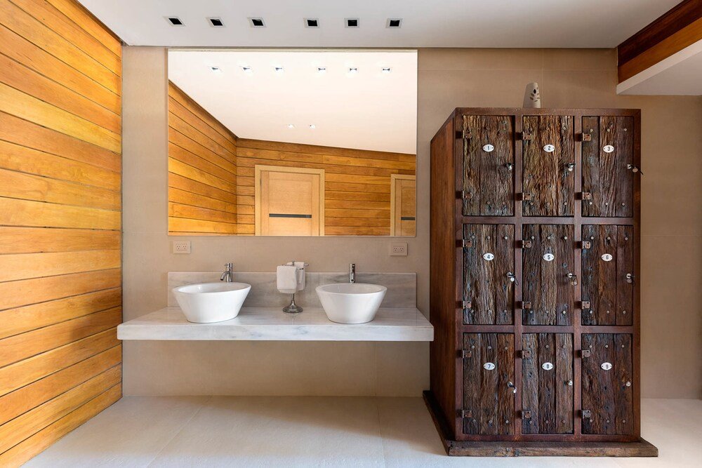 Baño moderno con paredes de paneles de madera y mesada de mármol
