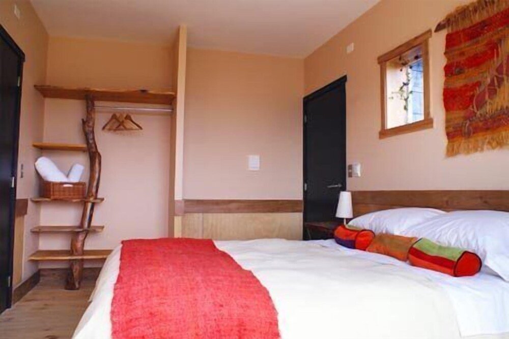 Bedroom with a bed and wooden details at the hotel