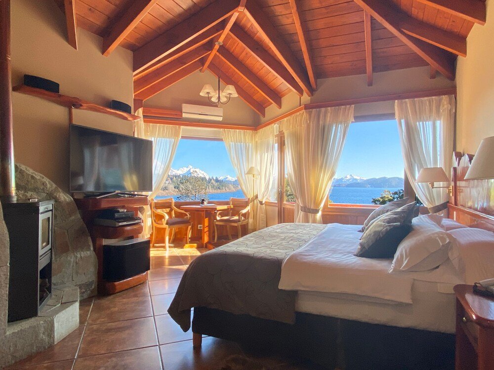 Bedroom with a bed, a television and a fireplace