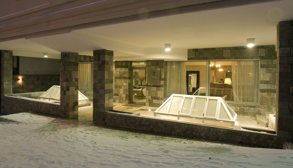 Hotel lobby with stone walls and a reception desk