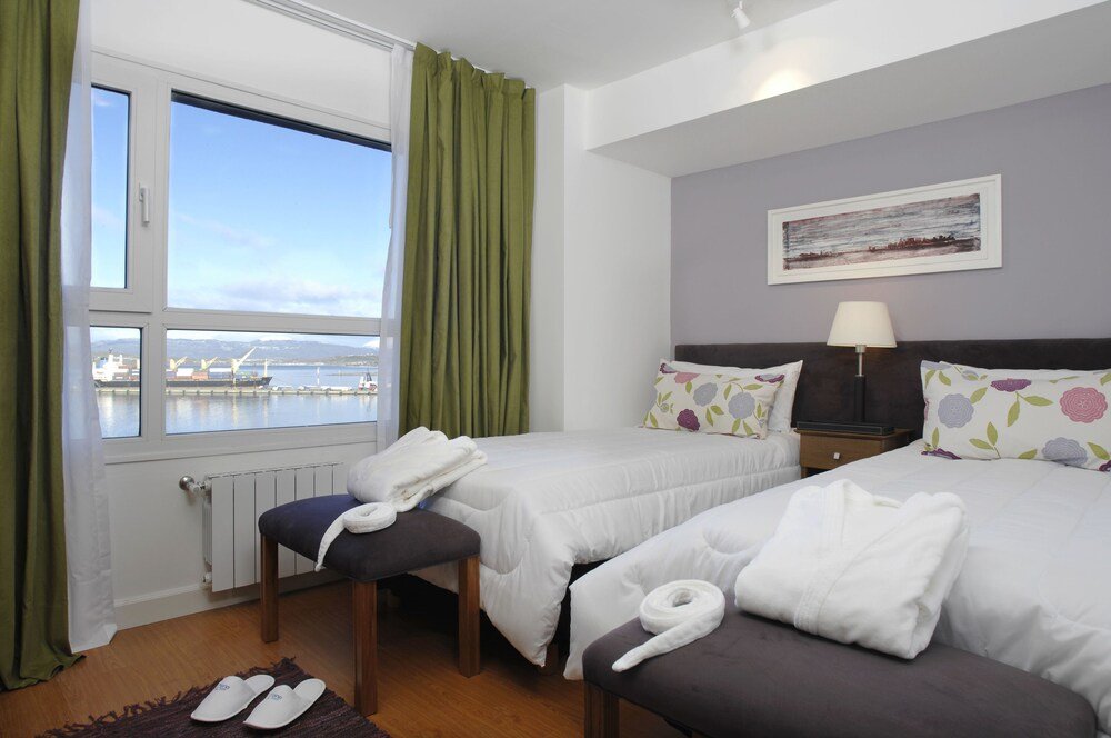Hotel room with two beds and a view of the harbour