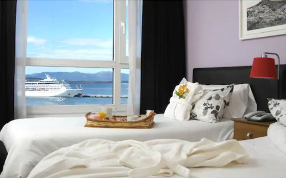 Hotel room with a bed and a red armchair