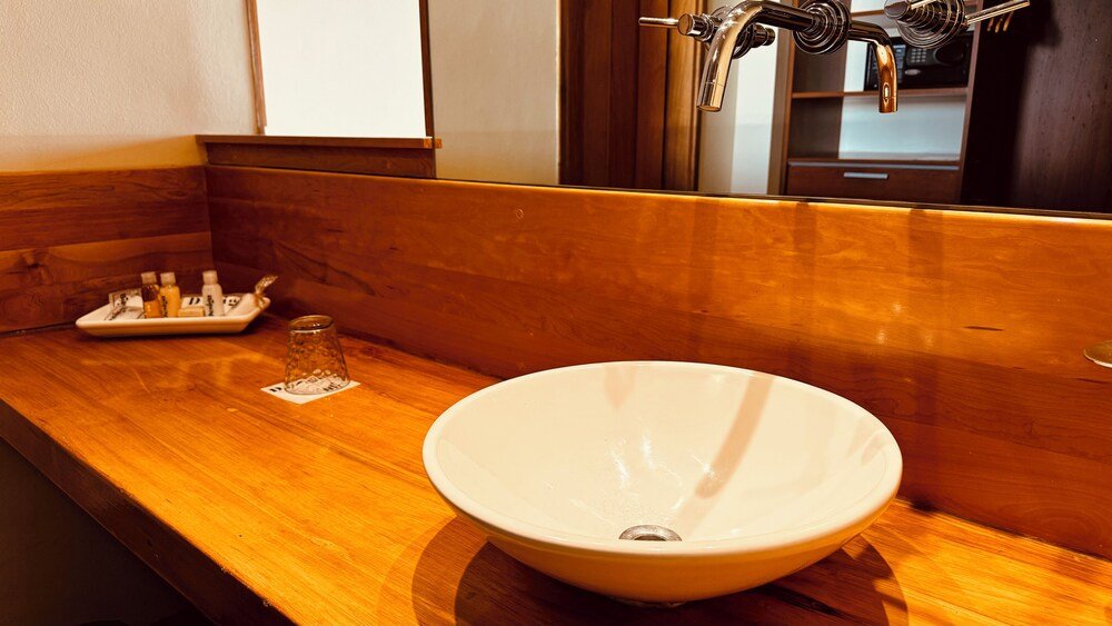 Bathroom with a wooden vanity at Design Suites Bariloche