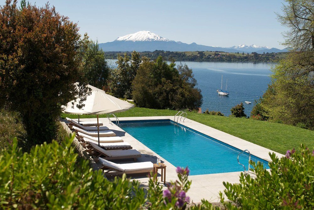 Outdoor pool with loungers at Enjoy Puerto Varas