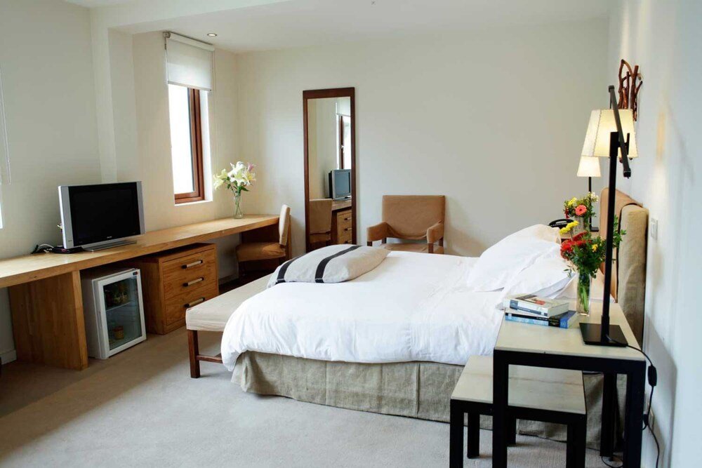 Guest room with bed and warm lighting at the hotel