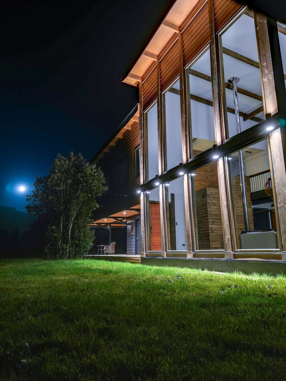 Modern house with large glass windows and wooden exterior