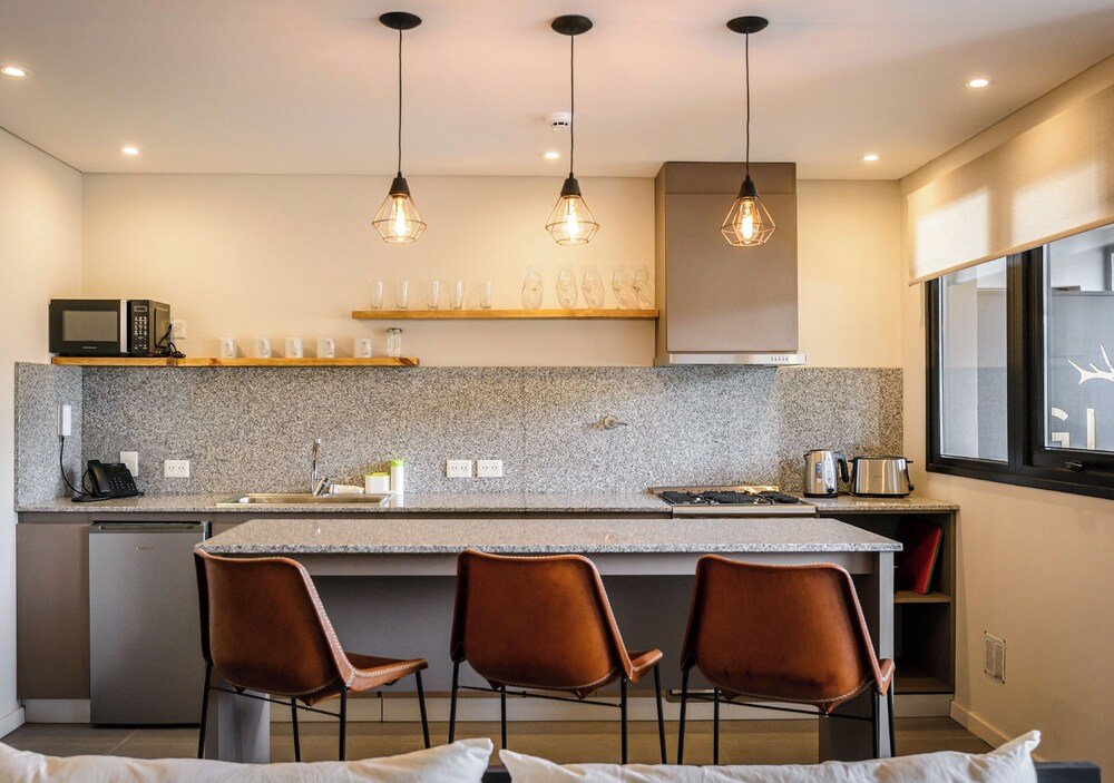 Modern kitchen with granite counters at Gluck Patagonia Aparts