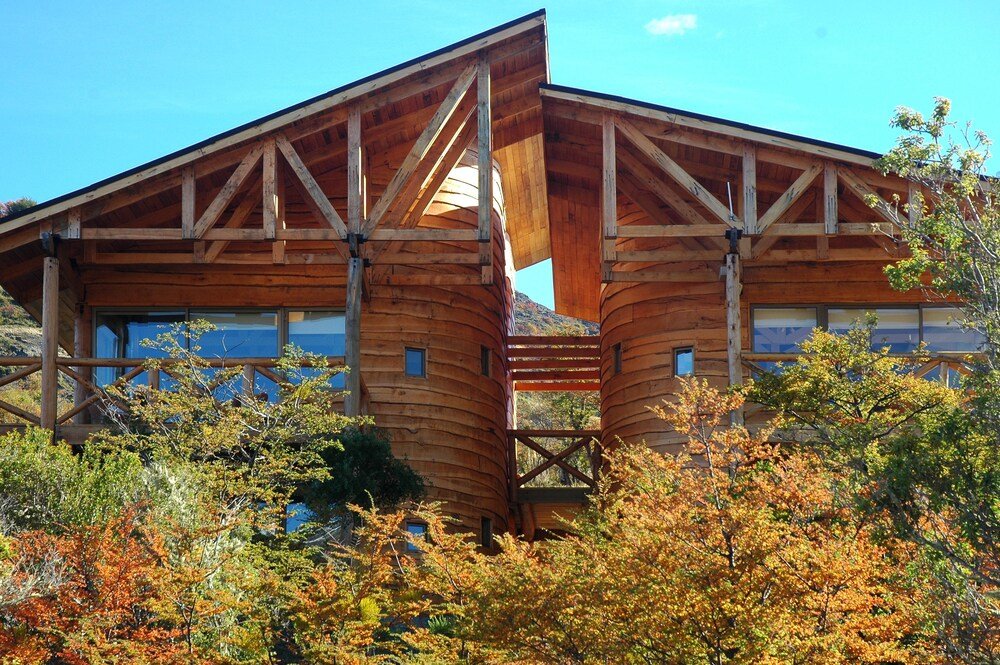 Wooden cabin with a curved roof and large windows
