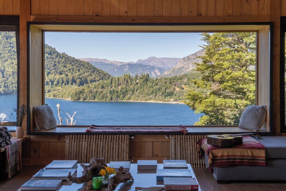 Room with a large window overlooking the surrounding landscape