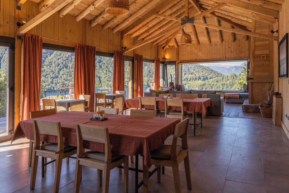Wooden dining area with tables set for meals at the lodge