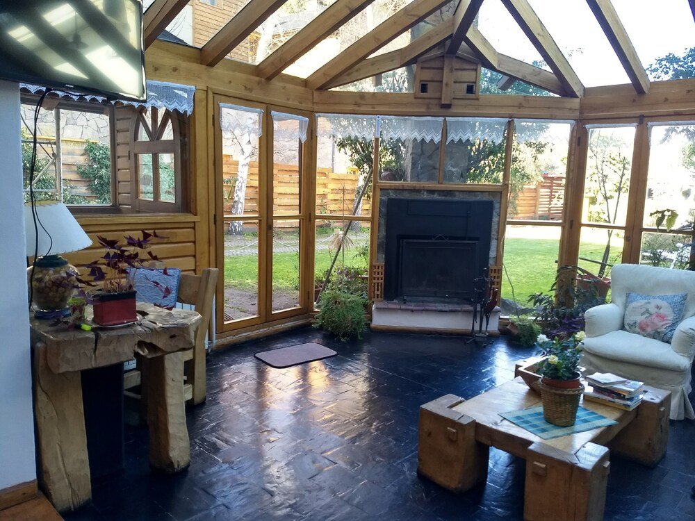 Cosy room with a fireplace, wooden furniture and large windows