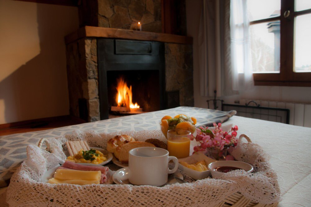 Breakfast tray with croissants, eggs, butter and juice