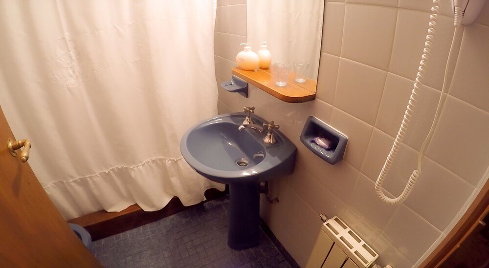 Bathroom with a sink, mirror, towel rack and shower