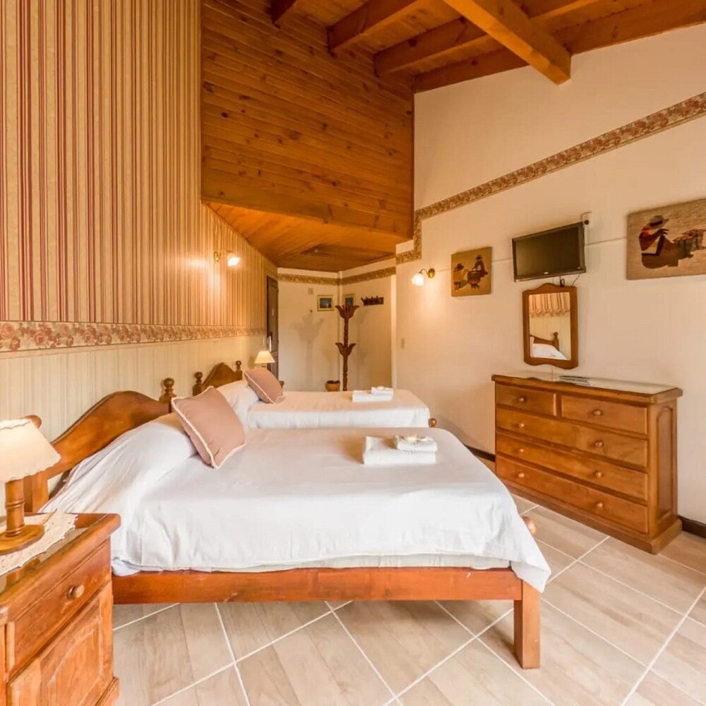 Another guest room at the lodge with beds and a desk