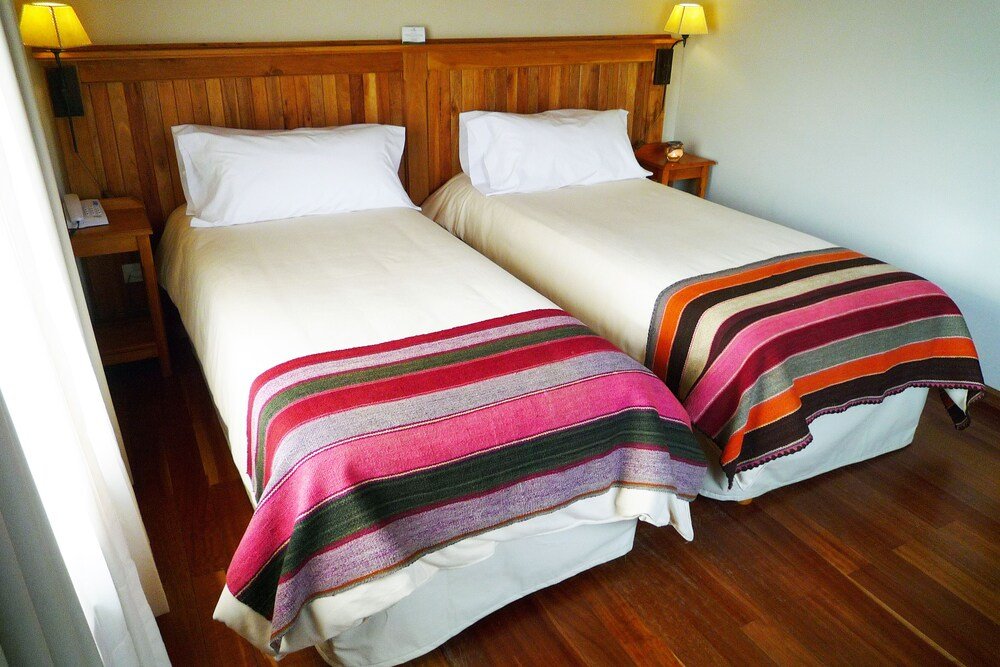 Two single beds with wooden headboards