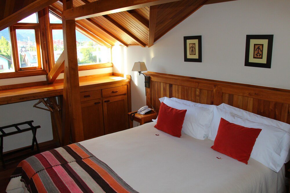 Bedroom with a large bed and wooden headboard
