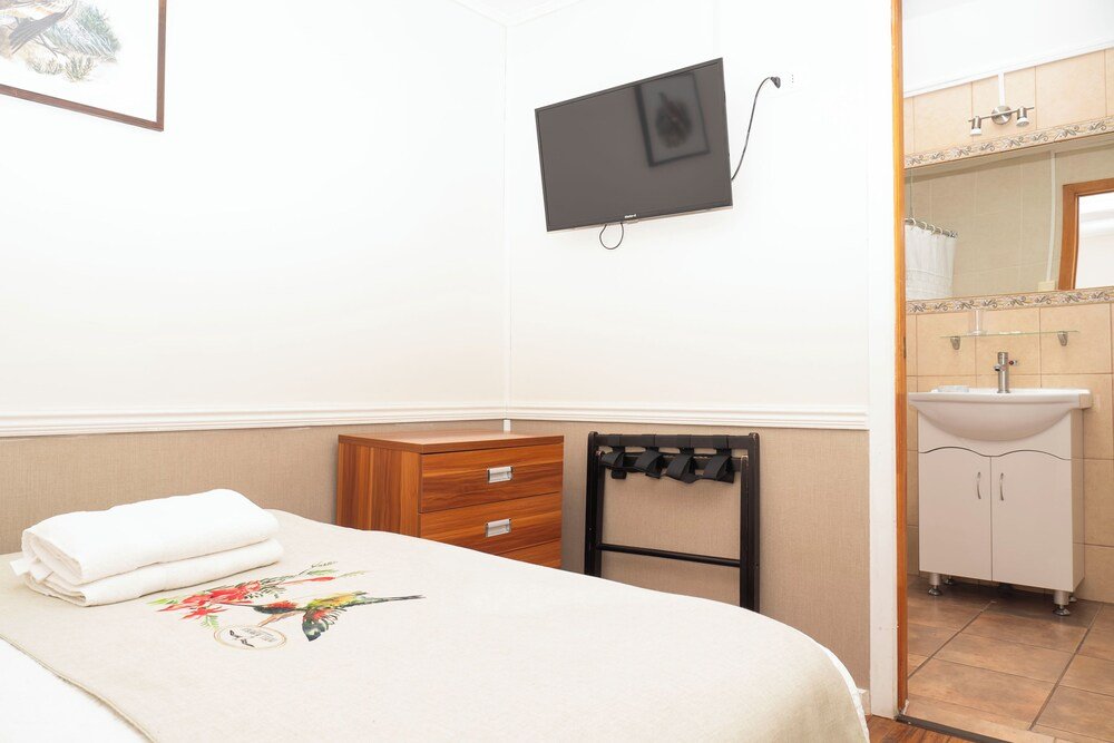 Hotel room with a bed and a TV