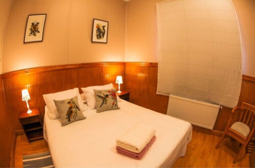 Simple hotel guest room with one large bed