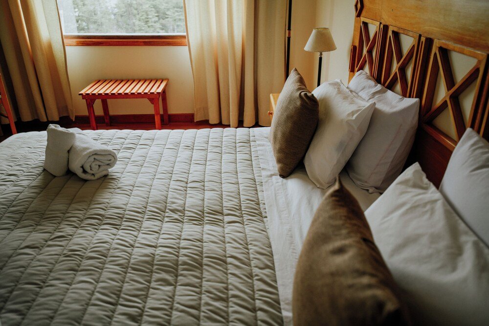 Neatly made bed with pillows