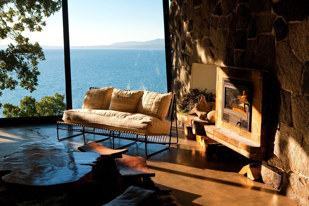 Cozy living room with a stone fireplace at Hotel Antumalal