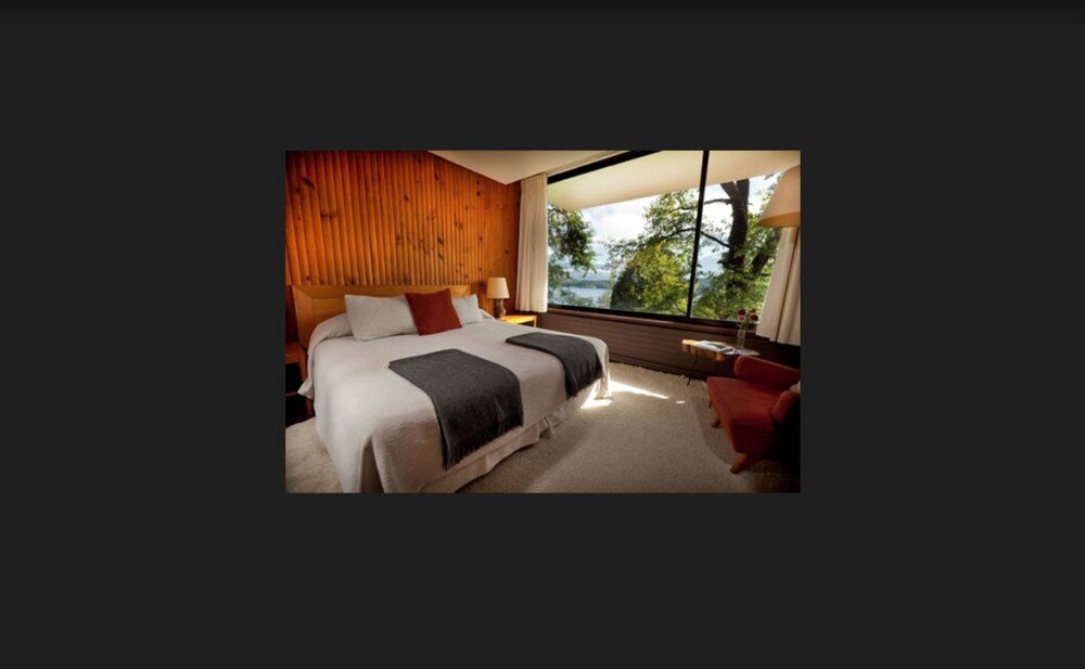 Modern hotel room with a large window at Hotel Antumalal