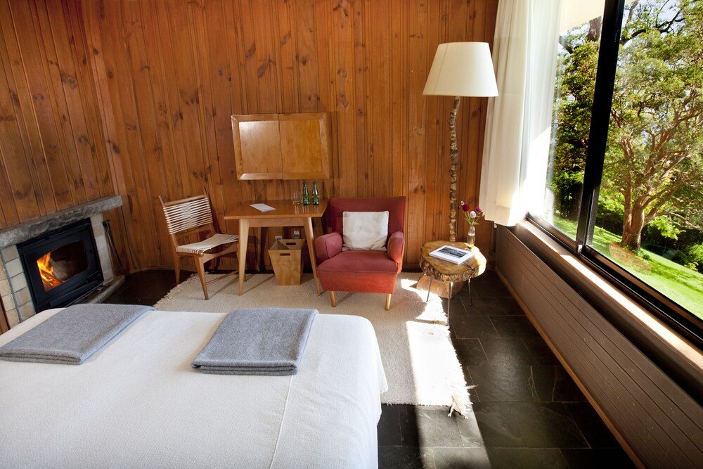 Wooden room with a bed and a desk at Hotel Antumalal