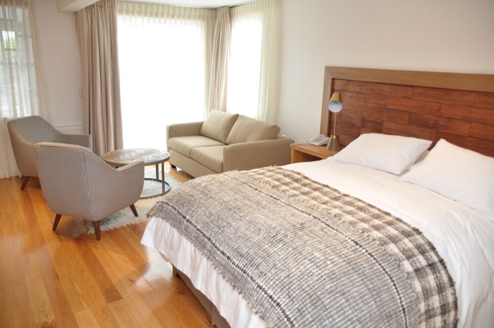 Hotel room with a large bed and simple decor