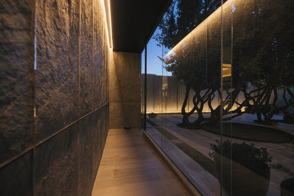 Corridor with a glass wall inside Hotel Cabo de Hornos