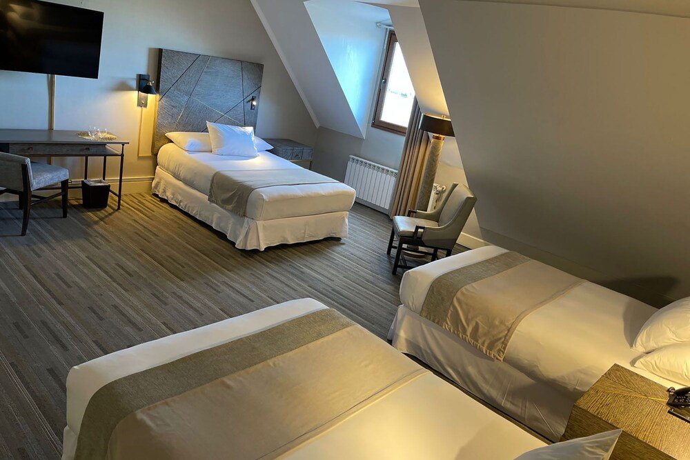 Modern hotel room with a loft-style bed at Cabo de Hornos