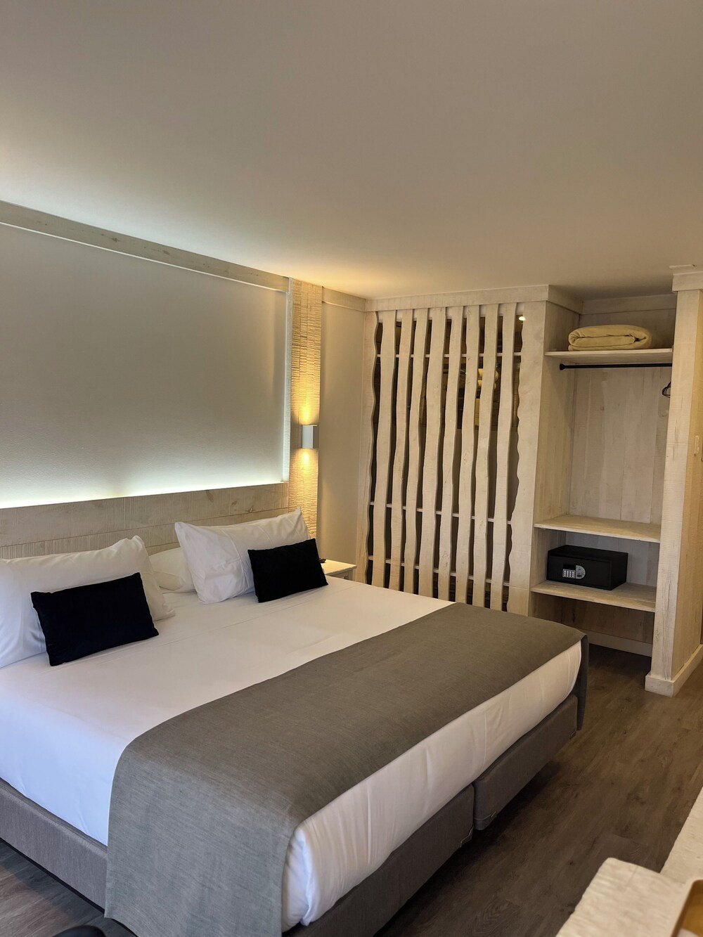 Habitación de hotel moderna con una cama grande bien tendida