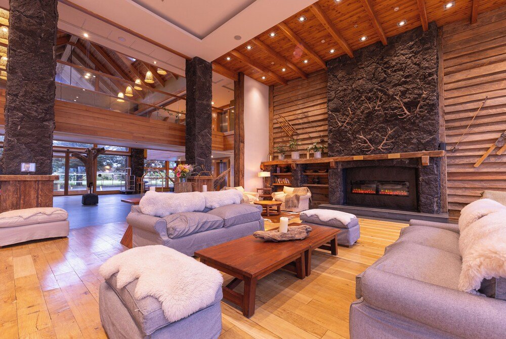 Spacious living area with a stone fireplace and seating