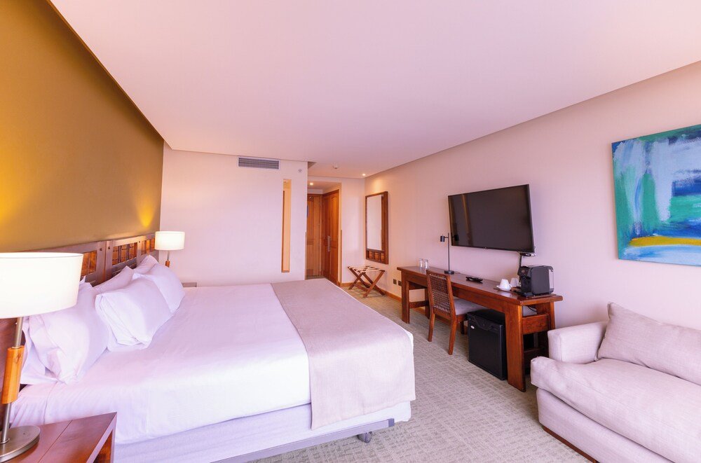 Guest room with desk and neutral decor at the hotel