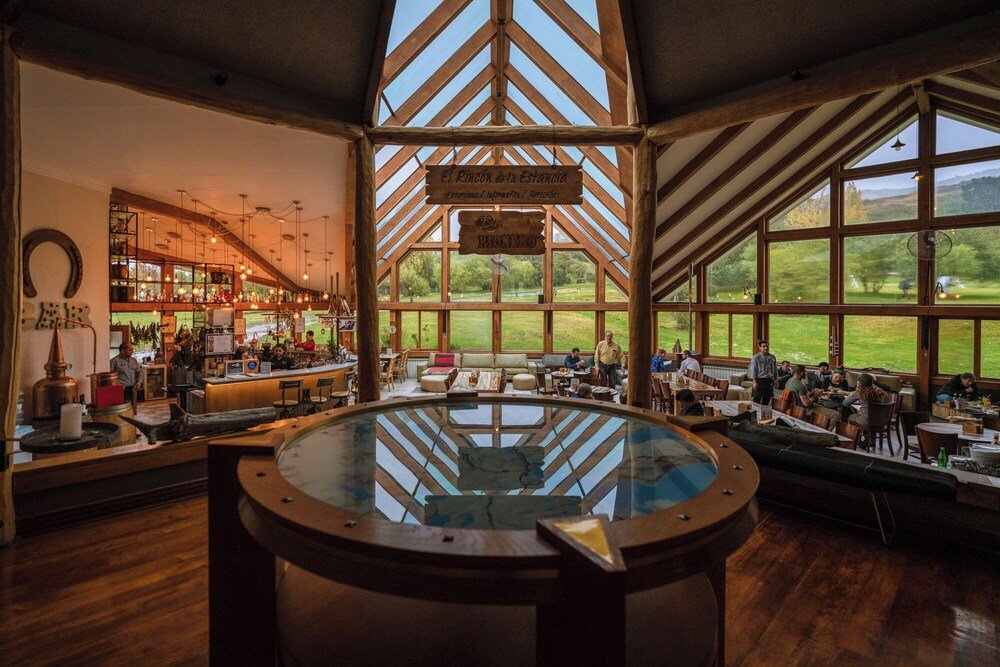 Restaurant with a large glass enclosure in the center and wooden beams