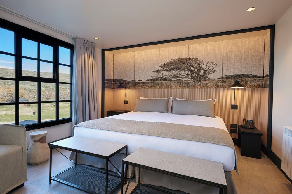 Modern hotel room with a large bed and bedside tables